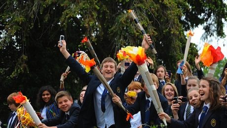 School children watch the Olympic Flame as the Torch travels through Bartestree